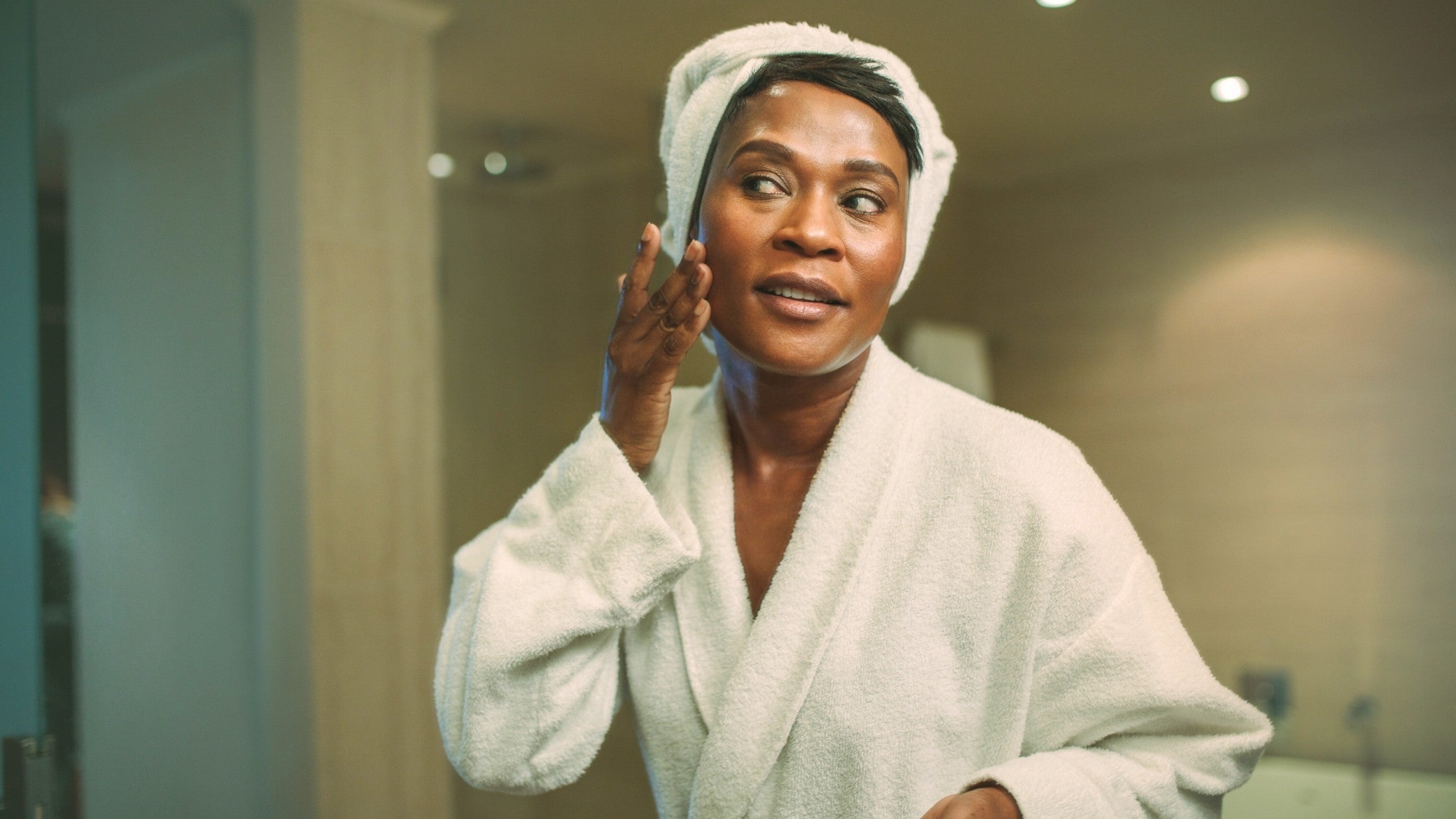 Black Woman applying IKNOW Night Cream