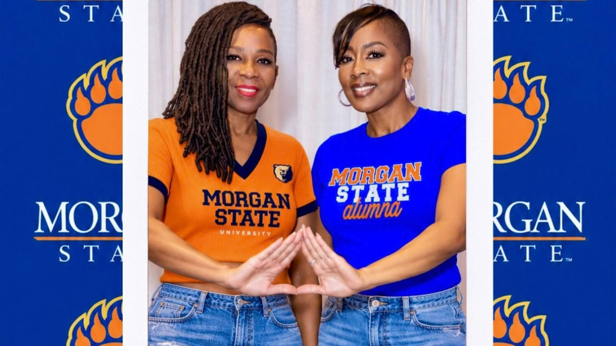 African American women wearing HBCU Morgan State paraphernalia doing the Delta Sigma Theta hand sign