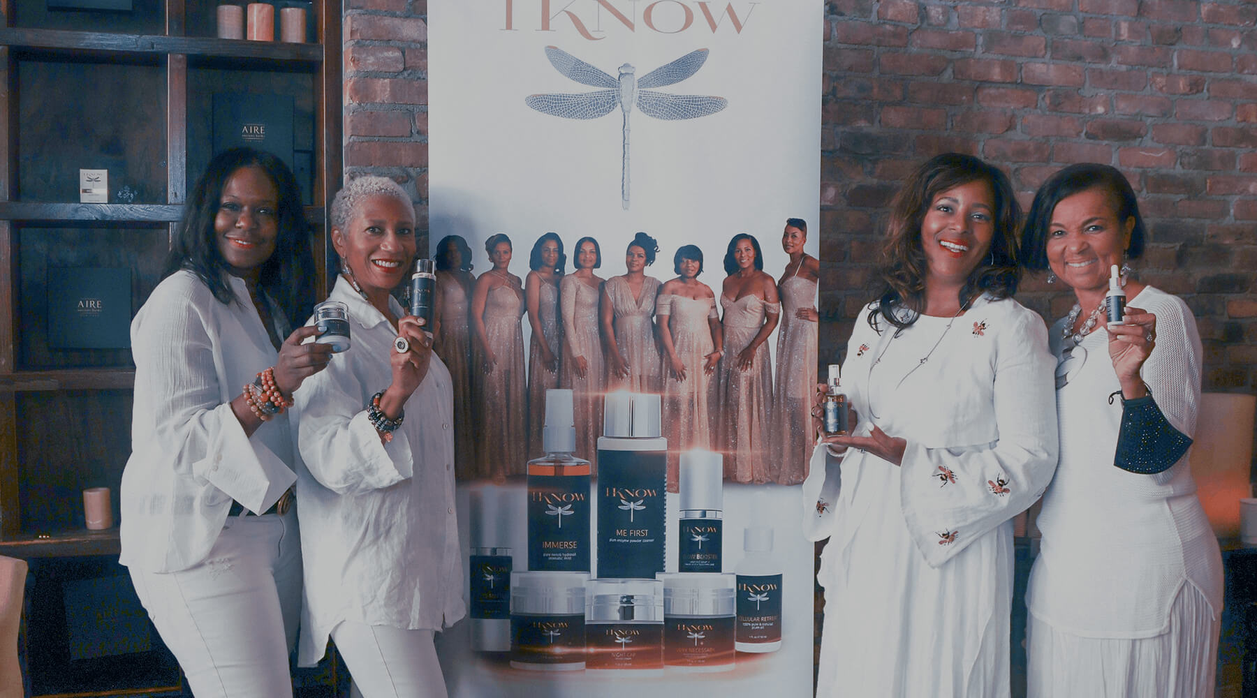 Four African american women holding skincare class=