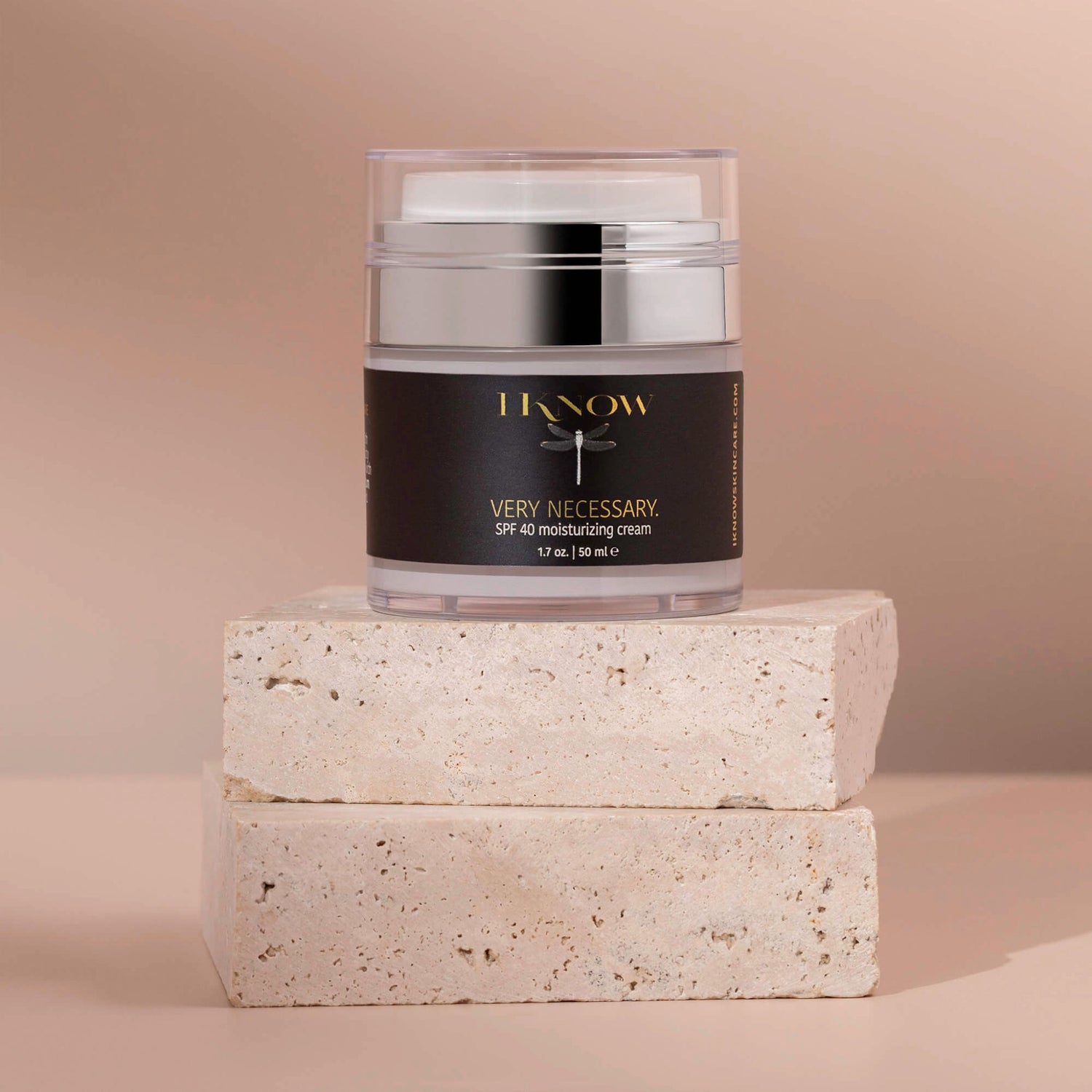 Woman of color applying moisturizer as part of a skin barrier care ritual