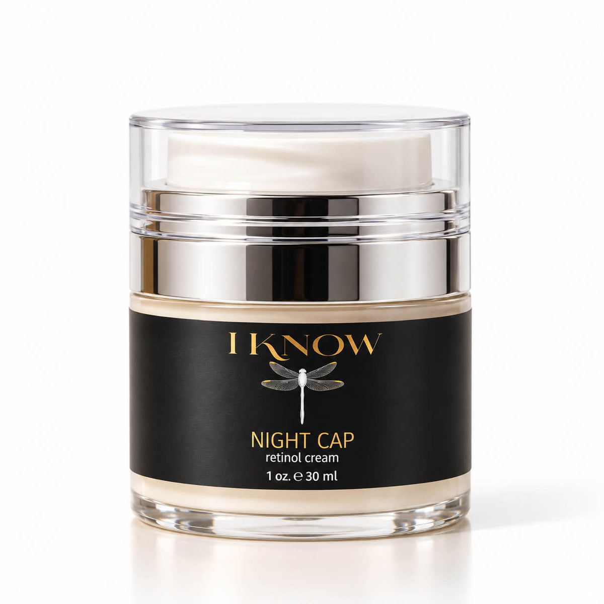 A jar of IKnow Night Cap Retinol Cream on a white background. The product is in a clear glass jar with a silver metallic collar and a black label featuring gold lettering and a dragonfly graphic.