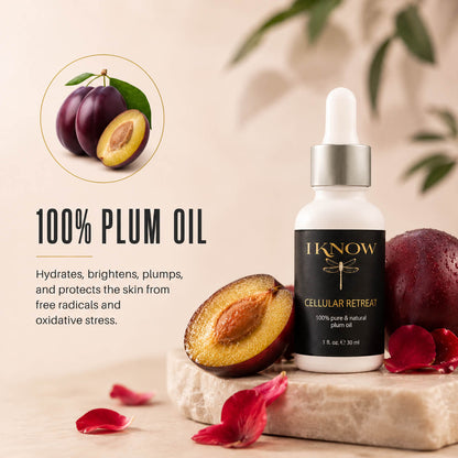 Bottle of 100% plum oil with plum fruits and leaves on a neutral background